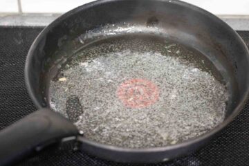 oil from canned mackerel in a large frying pan