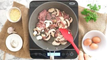 person frying chopped bacon and mushrooms in fry light low calorie cooking oil spray