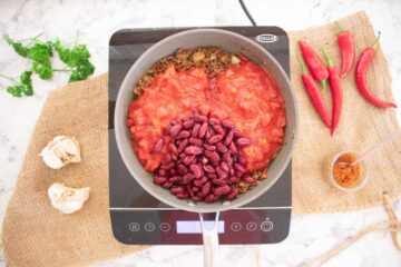 red kidney beans and tinned chopped tomatoes with beef mince in a large frying pan