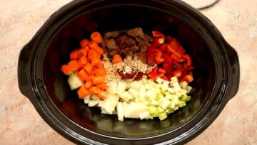 beef and vegetables with oats to thicken in a crock pot read to cook