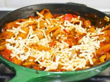 grated cheese on top of a sausage pasta bake before going back in the oven to melt