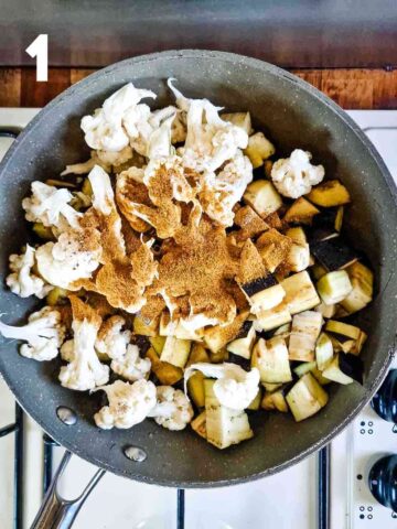 raw diced eggplants, cauliflower florets and curry spices in a large saute pan