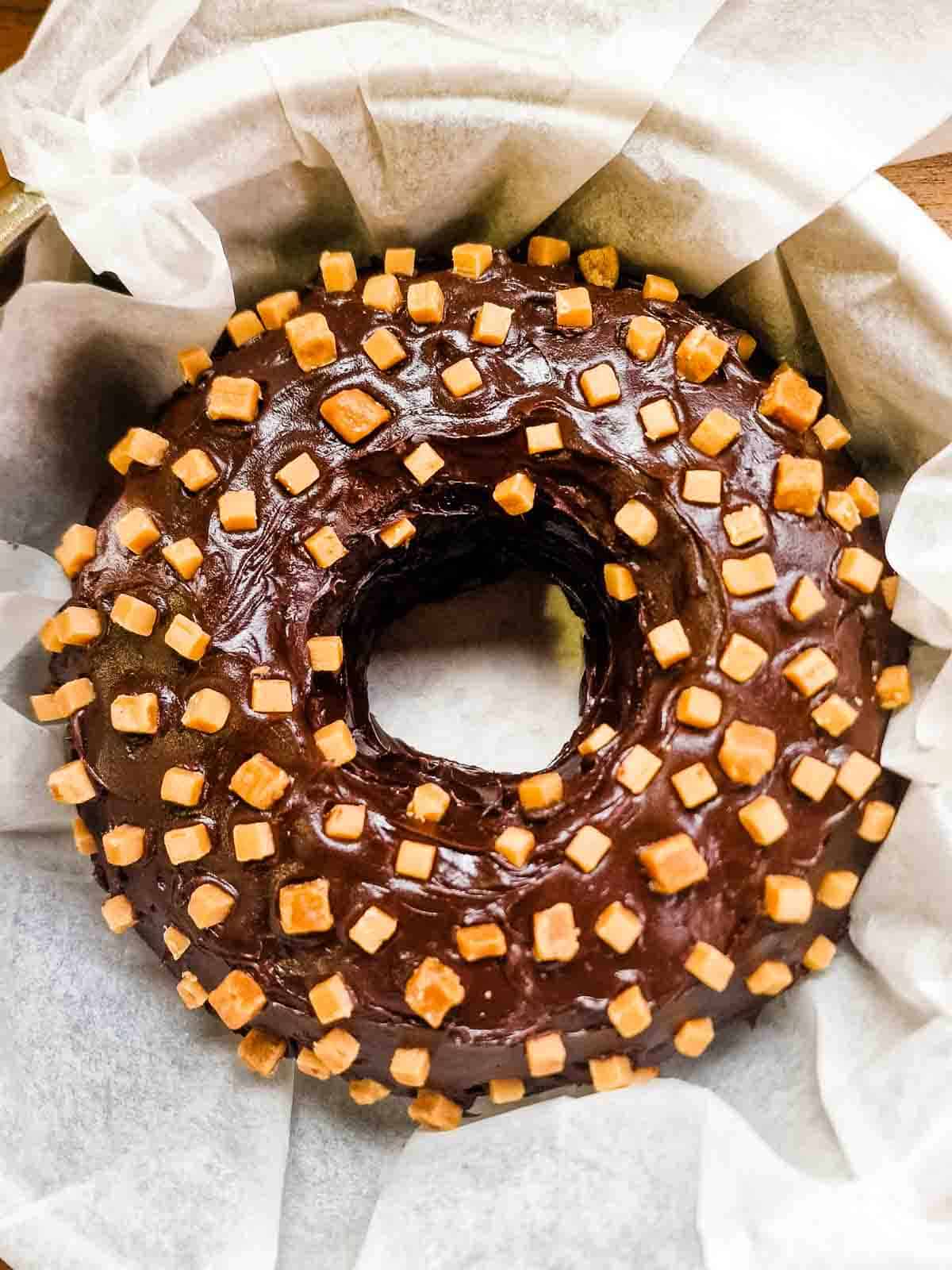 Giant bronut in a large dish lined with baking paper to deliver in person