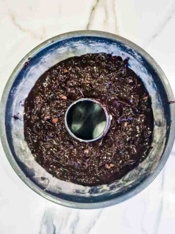 chocolate brownie donut batter in a prepared fluted cake pan