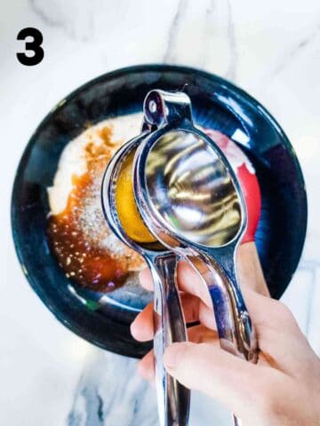 person squeezing lemon juice into wet ingredients for Coronation chicken
