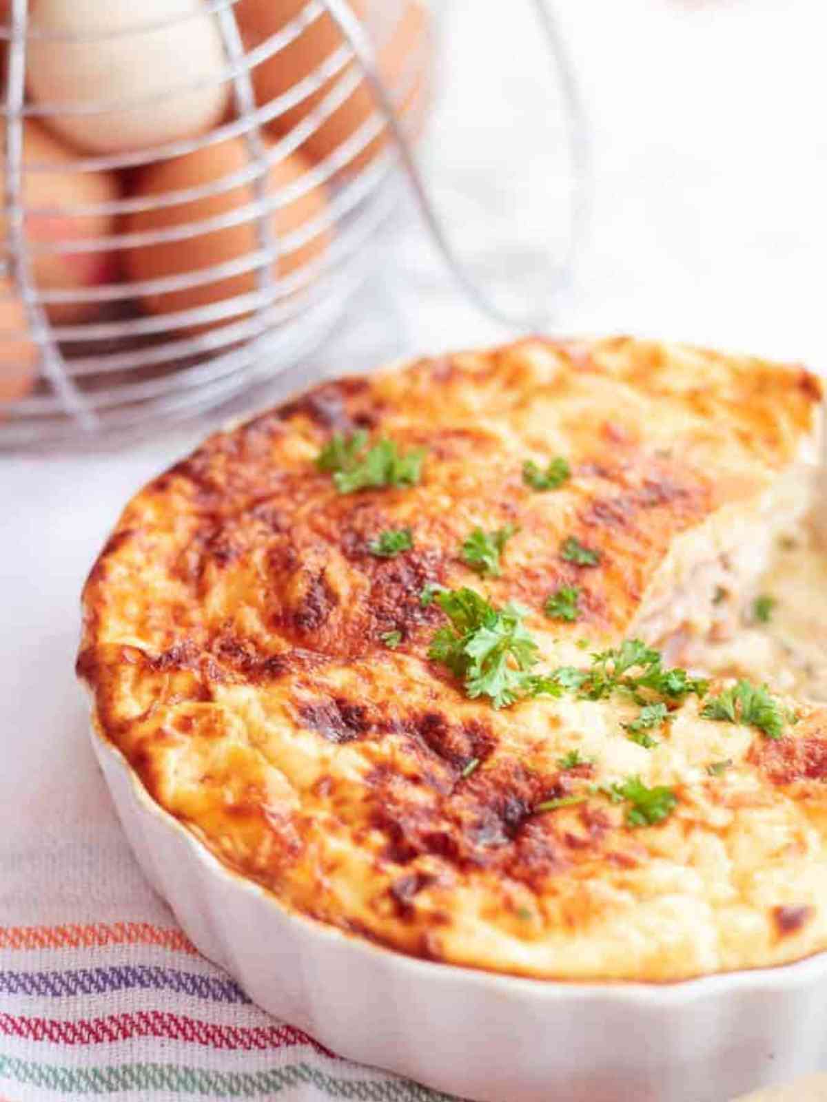 close up of slice of bacon and egg pie missing fom quiche dish
