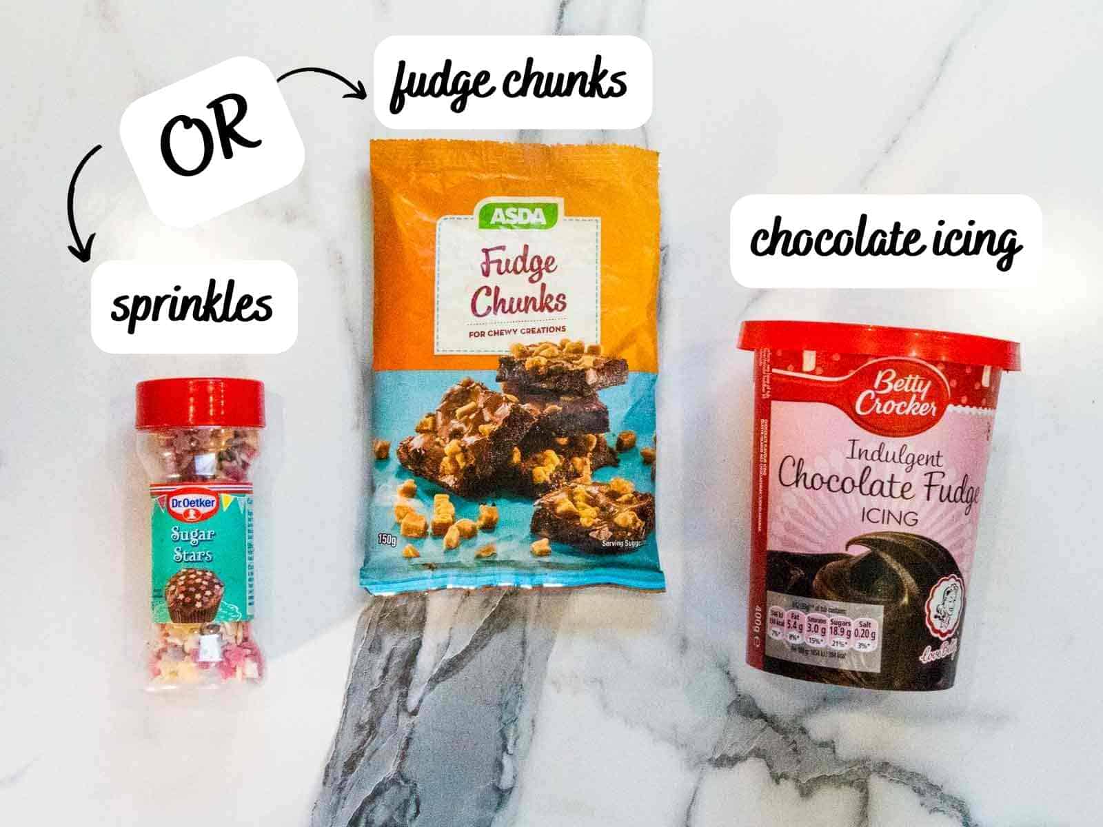 labelled ingredients for celebratory brownie cake topping with easy Betty Crocker icing, Asda fudge and Dr etker sugar stars