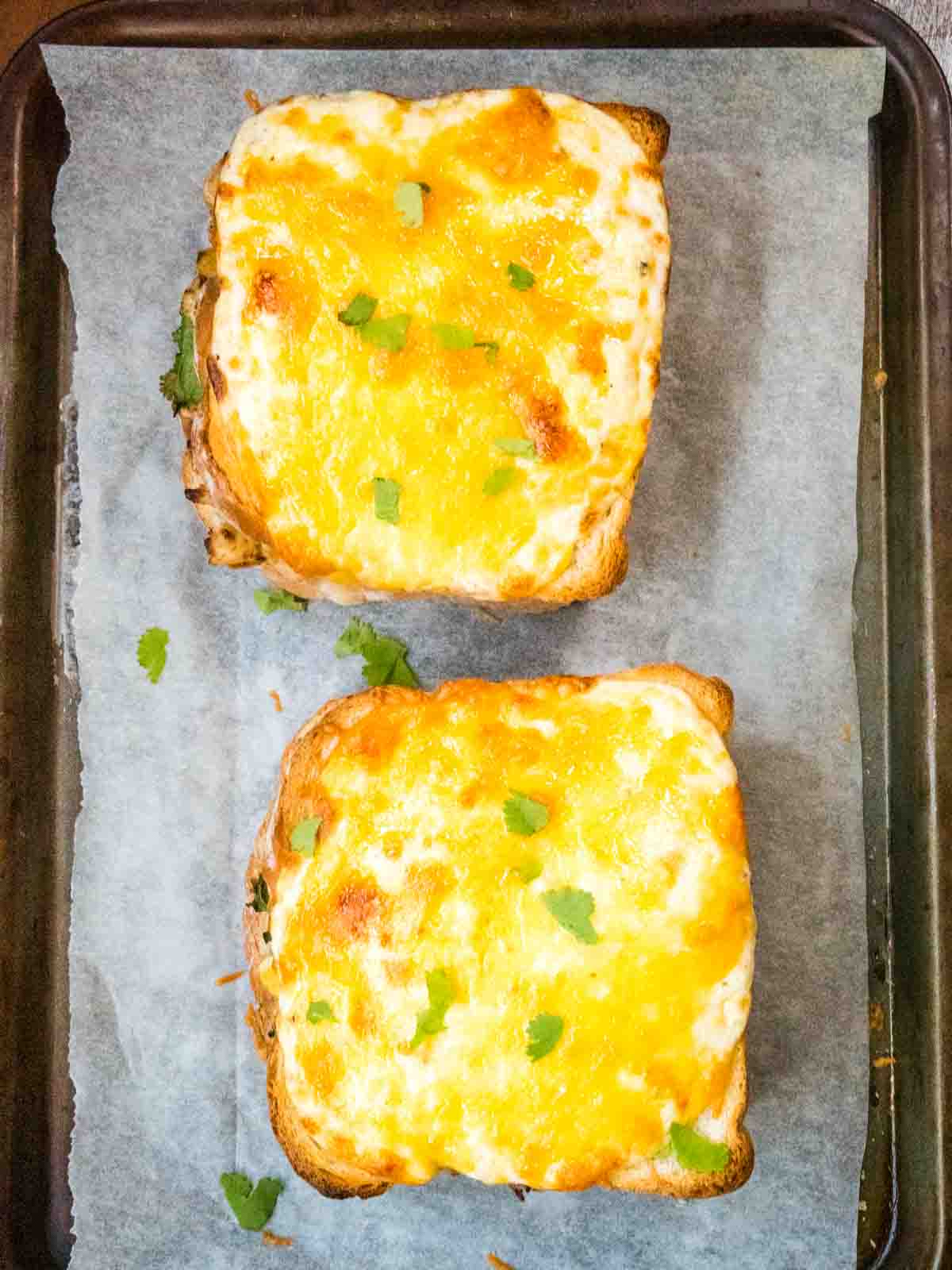 Bechamel sauce and grilled mature cheddar cheese malted on oven baked sandwiches for a Croque Monsieur French sandwiches