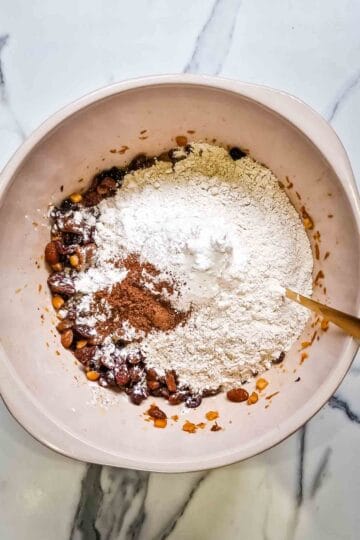 making a fruit loaf batter in a large bowl by mixing all of the dry and wet ingredients together in a large bowl