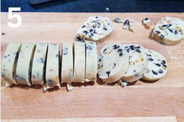 sliced fruit shortbread biscuits on a chopping board after hardening in the fridge