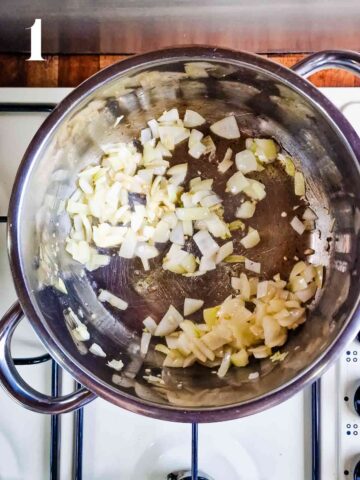 person frying onions and garlic to make the base of a soup