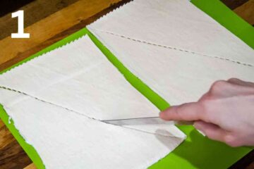 person scoring canned croissant dough along the perforated lines