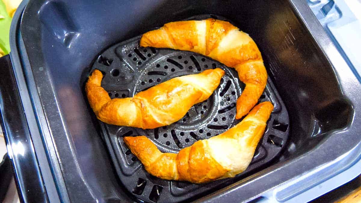 3 baked croissants in an air fryer