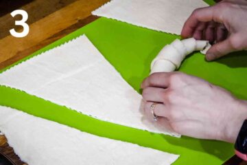 person curving the croissant ends for a crescent shape