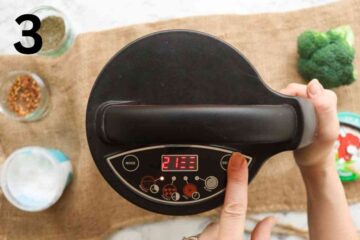 person selecting smooth mode on soup maker