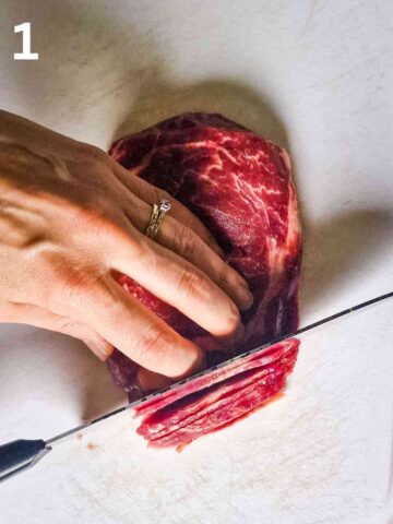 person thinly slicing beef rump steak against the grain with a sharp knife on chopping board