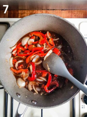 person stirring a homemade sweet chilli sauce in a pan with fried vegetables