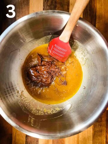person stirring melted chocolate into a butter and sugar mixture