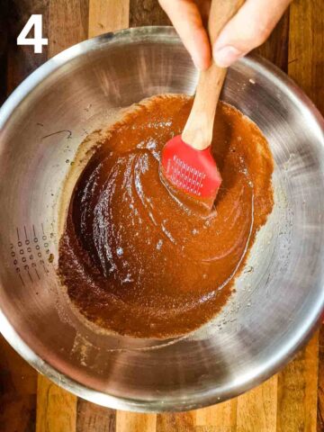 person stirring chocolate into a mixing bowl until fully combined