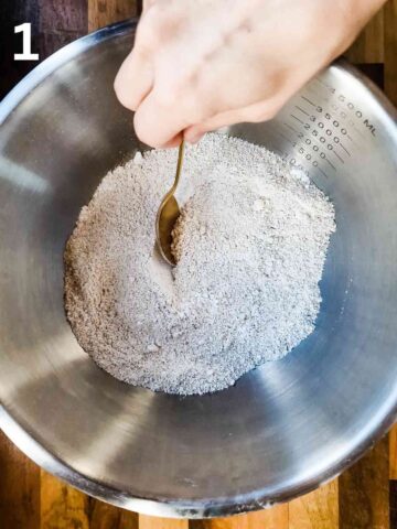 person mixing oat floru and baking powder together in a large mixing bowl