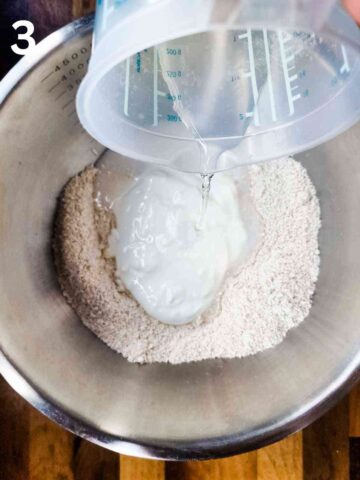 person pouring lemonade into a large mixing bowl with oat flour and cottage cheese
