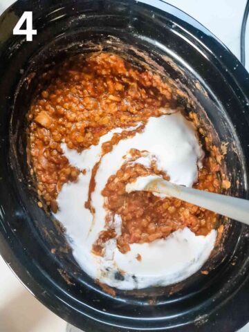 person pouring coconut milk into slow cooked red lentil dahl recipe