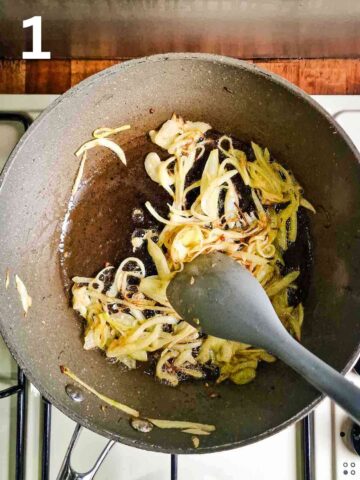 person sauteeing finely sliced white onions in large frying pan