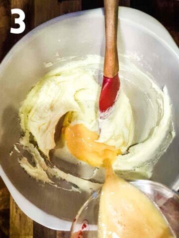 person pouring in beaten egg to mix the wet ingredients first for a cherry maderia cake batter