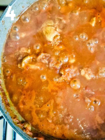 simmering pot of chicken pathia with chicken stock, canned tomatoes, bay leaf, tomato puree