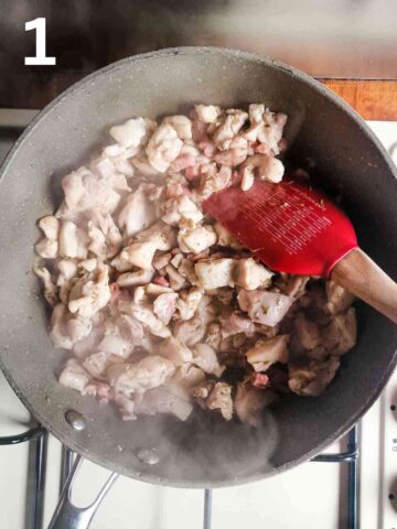 person frying lardons and diced chicken thighs in a large fring pan
