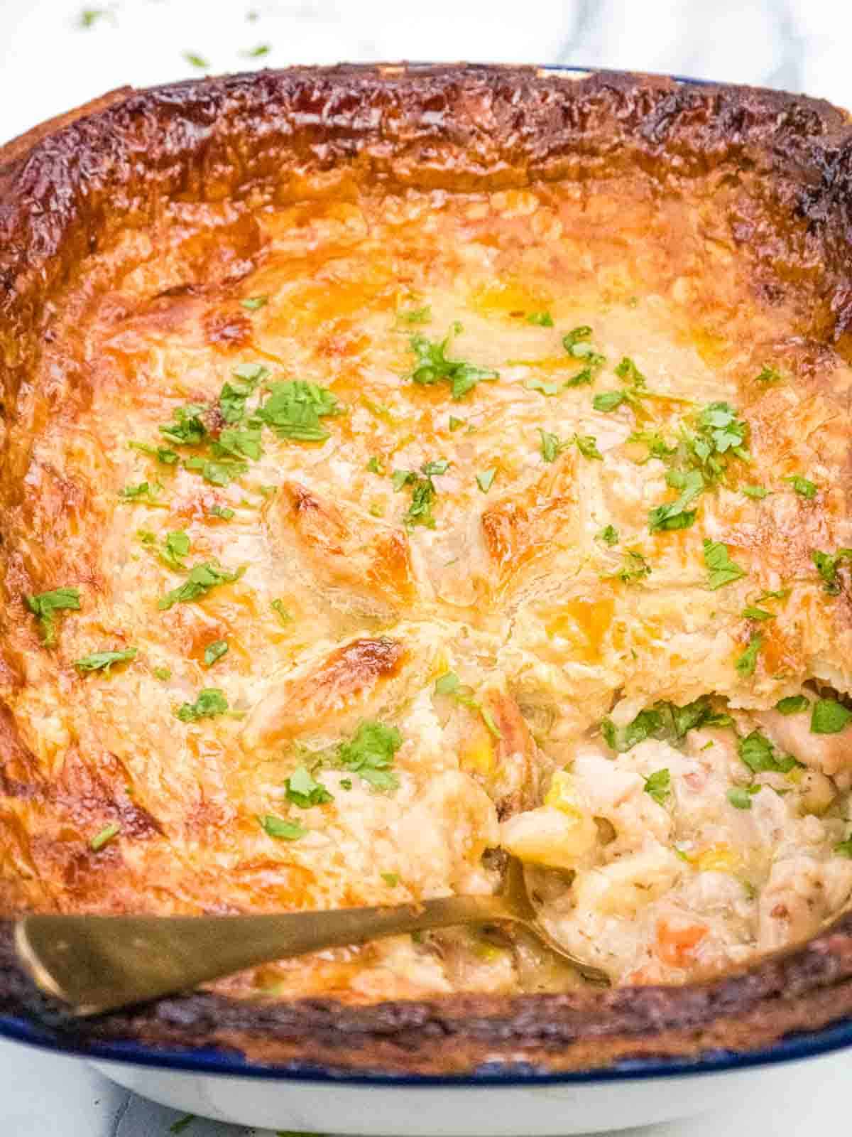 close up of flaky puff pie pastry wih creamy and herby chicken filling