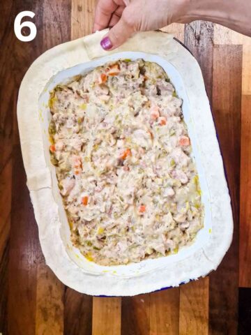 person pressing puff pastry strips all the way around a pie dish rim