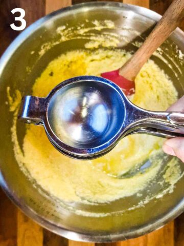 person squeezing lemon juice into cake mixture