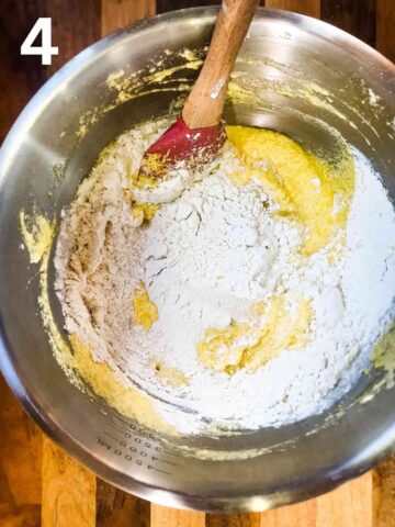 person mixing self raising flour eggs, butter and sugar with lemon juice and zest for a lemon cupcake batter