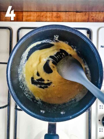 person making a fluor and butter roux in saucepan on hob