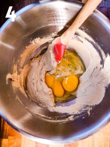 person mixing eggs into butter and sugar to make a sponge cake
