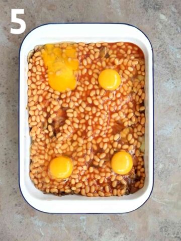 4 eggs cracked on top baked beans in baking dish