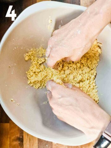 person rubbing butter and flour together with fingertips to get crumble breadcrumbs