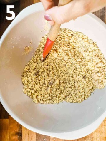person stirring in sugars into fruit crumble topping