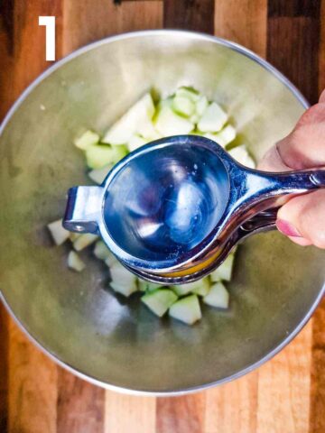 squeezing lemon juice on chopped apples to prevent them from browning