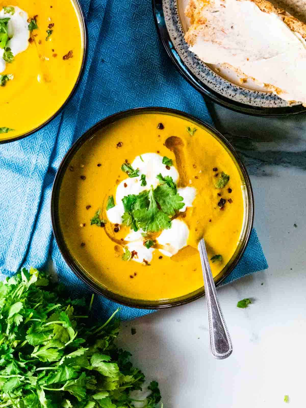 close up cream, coriander, chilli on creamed carrot courgette soup