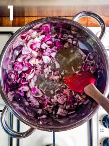 person gently frying red onions, garlic and seasoning in a pan