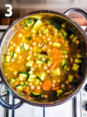 stock and vegetables added to carrot courgette soup recipe in a pan