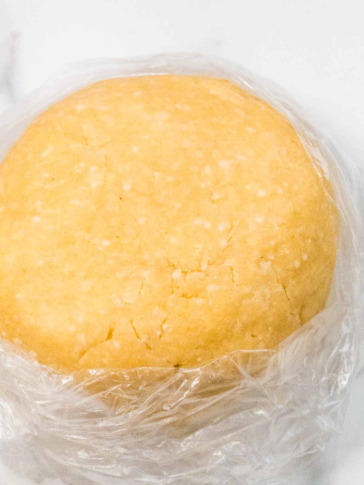 close up of a cheesy pastry raw dough in plastic food bag