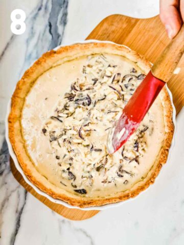 quiche filling being evenly distributed in a part baked quiche shell