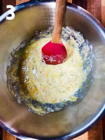 person mixing eggs, cream, seasoning and spices in a large mixing bowl