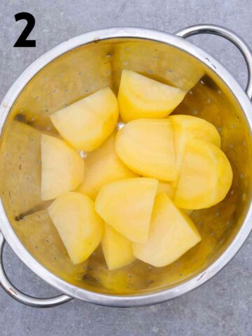 drained parboiled potatoes in a colander
