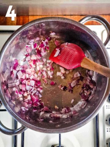 person gently frying diced red onions in large saucepan