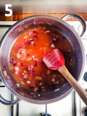 person cooking broth for soup with onions