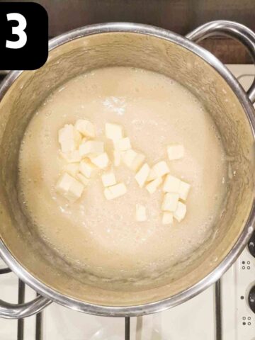 diced butter added to apple sauce in pan